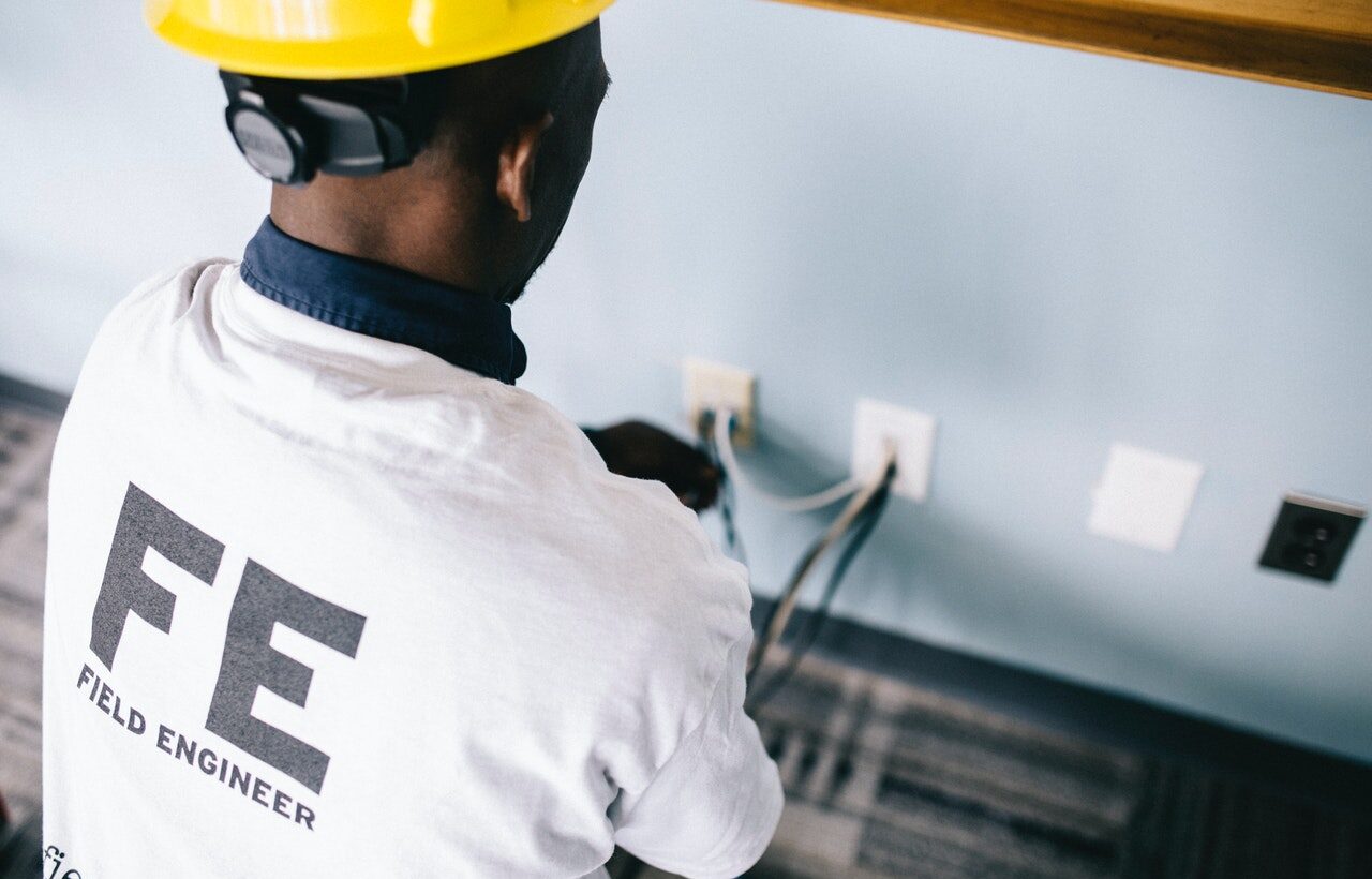 person handling electrical wires